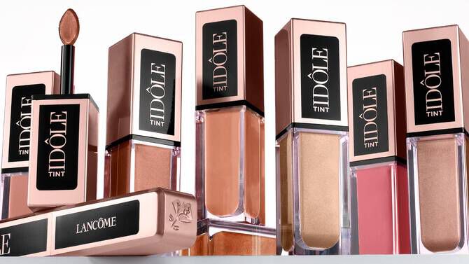 A collection of Lancome Idole Tint lip products, featuring various shades in elegant packaging, arranged aesthetically.