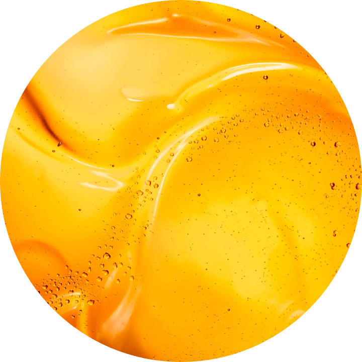 Tekstura jasnopomarańczowego żelu ze wstawkami bąbelkow powietrza na gładkiej powierzchni.