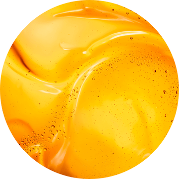 Tekstura jasnopomarańczowego żelu ze wstawkami bąbelkow powietrza na gładkiej powierzchni.