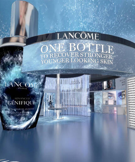 An artistic representation of a Lancome product display featuring a bottle of Genifique serum, surrounded by vibrant visuals and text promoting stronger, younger-looking skin. The background features soft blue tones and images of smiling faces.