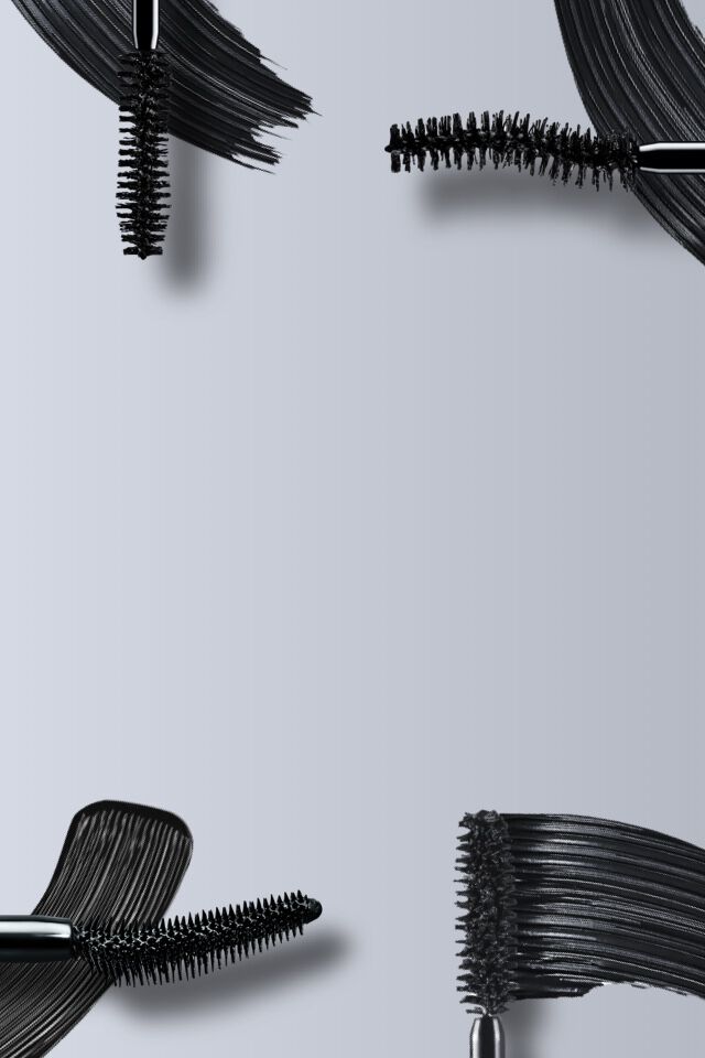 Cztery szczoteczki do tuszu do rzęs na szarym tle.